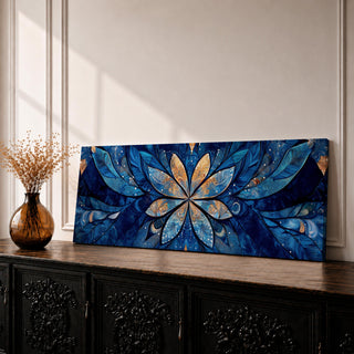 Panoramic floral mandala artwork featuring a symmetrical lotus flower design with layered petals spreading outward in deep blue and gold tones, accented with delicate botanical shapes and watercolor textures that create an intricate ornamental pattern across a wide horizontal composition.