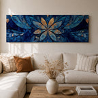 Panoramic floral mandala artwork featuring a symmetrical lotus flower design with layered petals spreading outward in deep blue and gold tones, accented with delicate botanical shapes and watercolor textures that create an intricate ornamental pattern across a wide horizontal composition.
