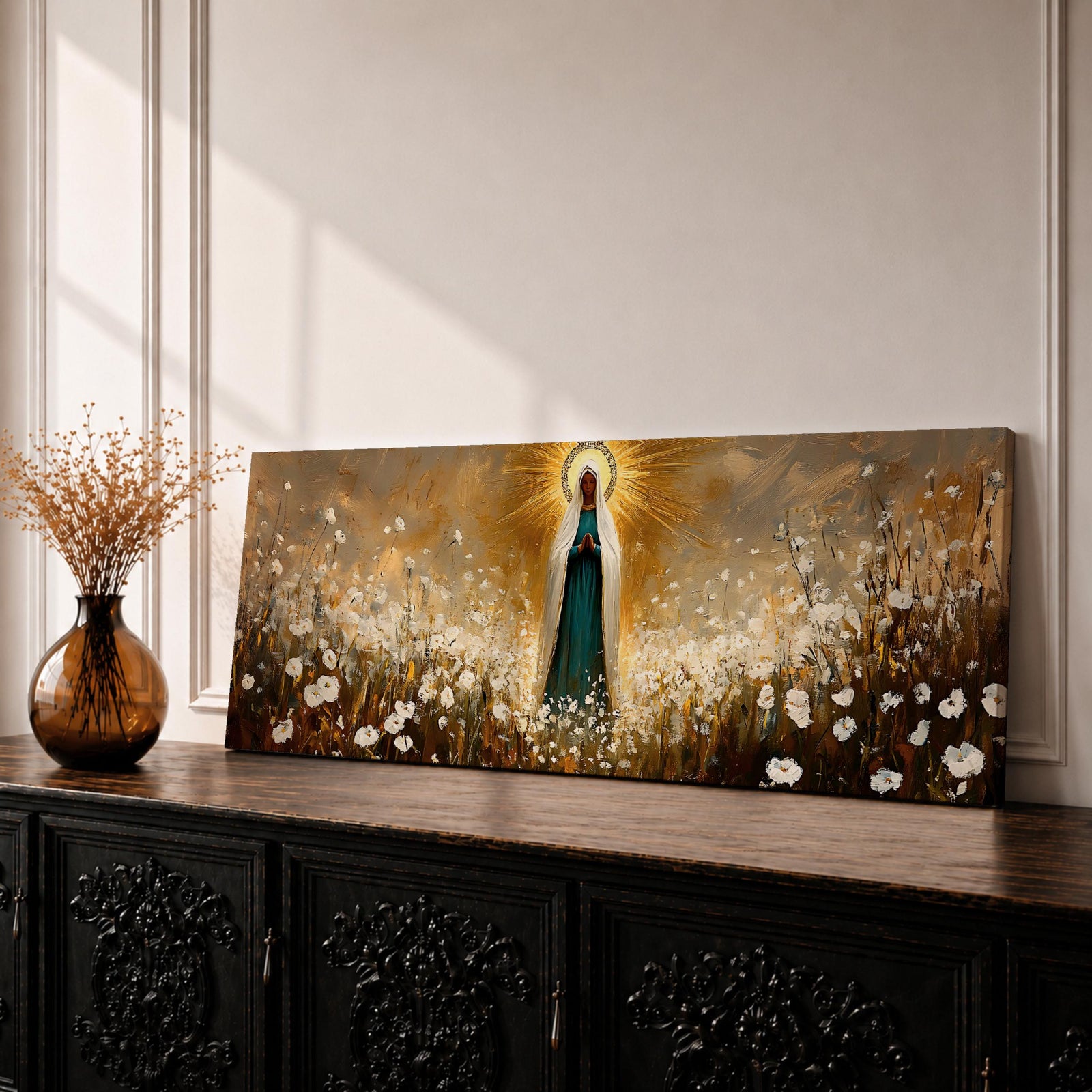 Panoramic religious painting depicting the Virgin Mary standing in a glowing field of white flowers with hands gently clasped in prayer, wearing a flowing robe and veil illuminated by radiant golden light forming a halo behind her, surrounded by soft natural scenery rendered in warm earthy tones and expressive brushstrokes.