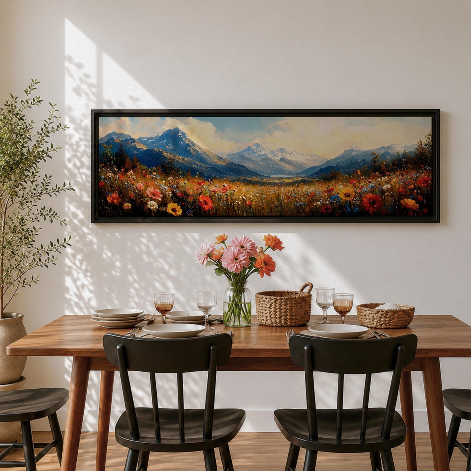 Panoramic landscape painting depicting a wide alpine meadow filled with colorful wildflowers in the foreground leading toward distant snow capped mountains, with rolling hills and soft clouds above, rendered in warm natural tones and expressive brushstrokes forming a sweeping scenic mountain vista.