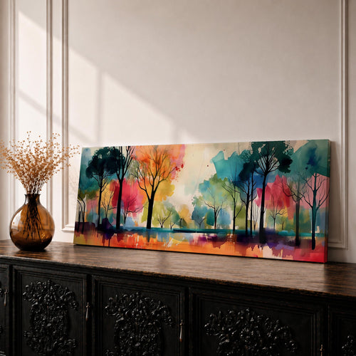 Panoramic abstract watercolor painting of a forest landscape with tall slender tree silhouettes reflected in still water, surrounded by vibrant washes of teal, orange, red, yellow, and green forming a colorful woodland scene with expressive brushwork and soft atmospheric blending.