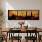 Panoramic artwork depicting a dramatic skyline of mosque domes and tall minarets silhouetted against a glowing golden sunset sky, with warm amber and orange tones diffused through atmospheric haze creating a striking Islamic architectural horizon.