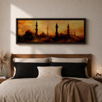 Panoramic artwork depicting a dramatic skyline of mosque domes and tall minarets silhouetted against a glowing golden sunset sky, with warm amber and orange tones diffused through atmospheric haze creating a striking Islamic architectural horizon.