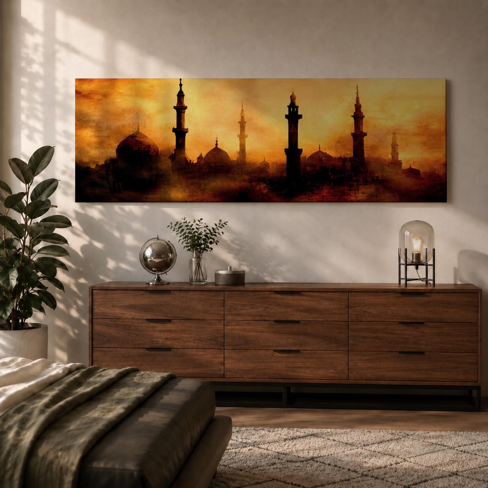 Panoramic artwork depicting a dramatic skyline of mosque domes and tall minarets silhouetted against a glowing golden sunset sky, with warm amber and orange tones diffused through atmospheric haze creating a striking Islamic architectural horizon.