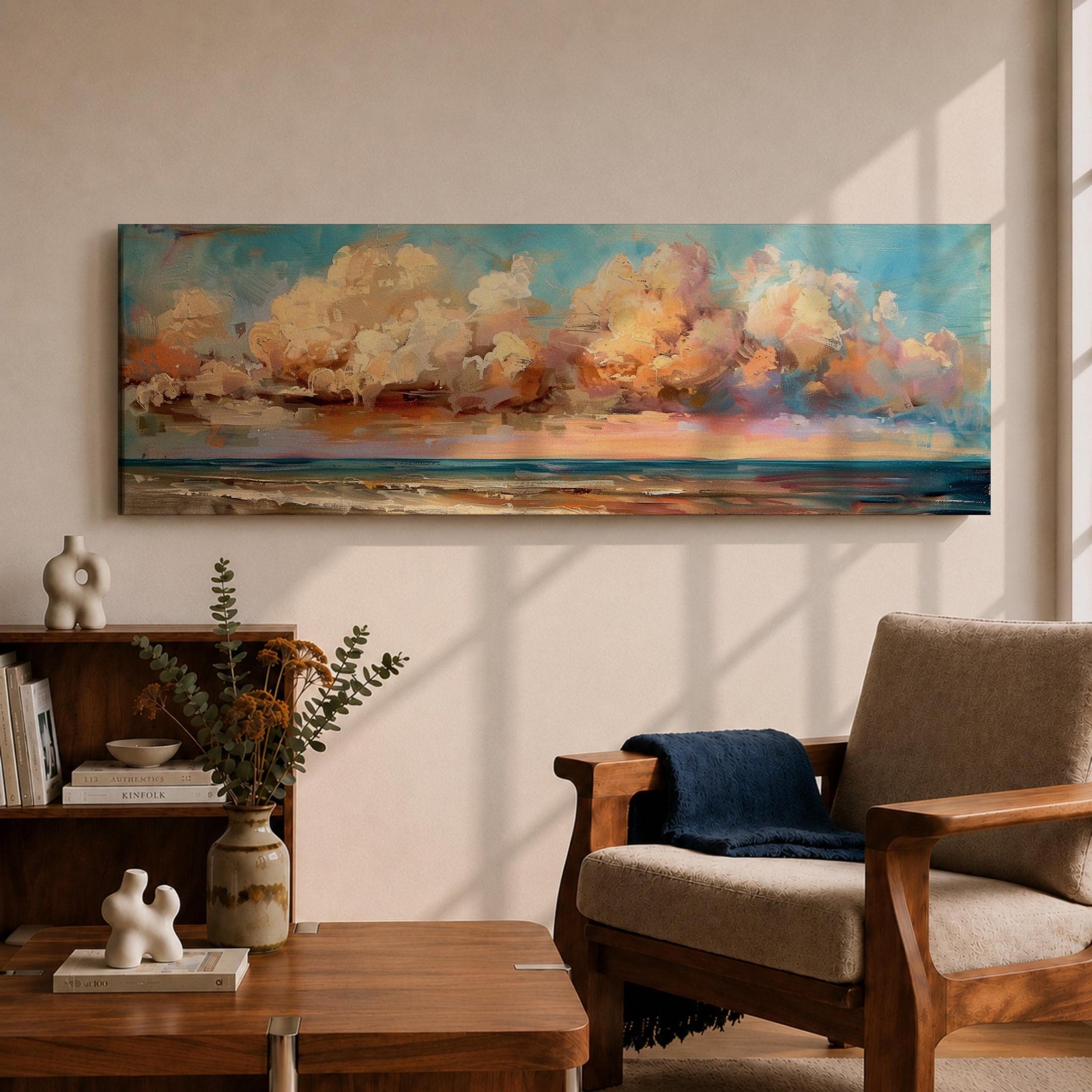 Panoramic coastal painting featuring dramatic sunset clouds above the ocean horizon with waves along a sandy beach, rendered in warm pastel sky tones and textured brushstrokes creating a peaceful seaside landscape.