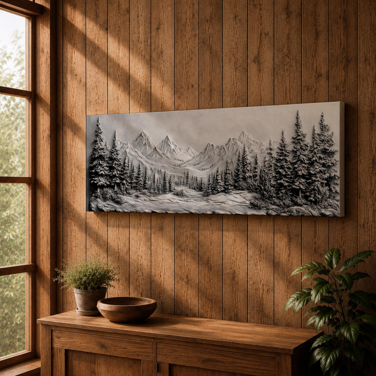 Panoramic monochrome landscape artwork depicting snow covered mountains and a dense pine forest with a winter valley scene rendered in black and white tones.