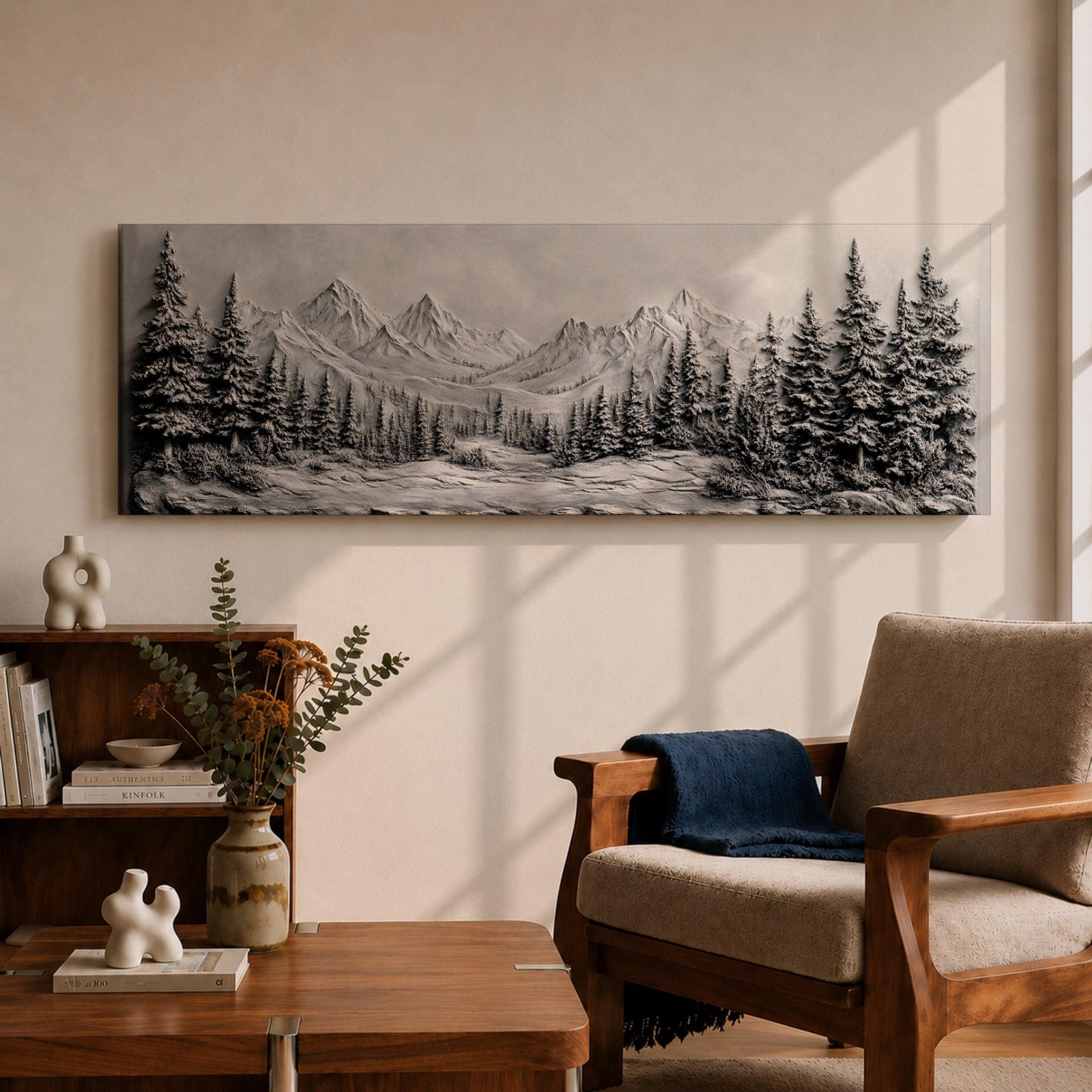 Panoramic monochrome landscape artwork depicting snow covered mountains and a dense pine forest with a winter valley scene rendered in black and white tones.