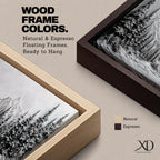 Panoramic monochrome landscape artwork depicting snow covered mountains and a dense pine forest with a winter valley scene rendered in black and white tones.