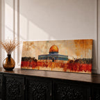 A panoramic abstract painting of the Dome of the Rock with its golden dome rising above the historic structure, rendered in textured brushstrokes with warm ochre, rust, and gold tones blending into a distressed background while dark silhouettes of trees and landscape stretch across the horizontal composition.