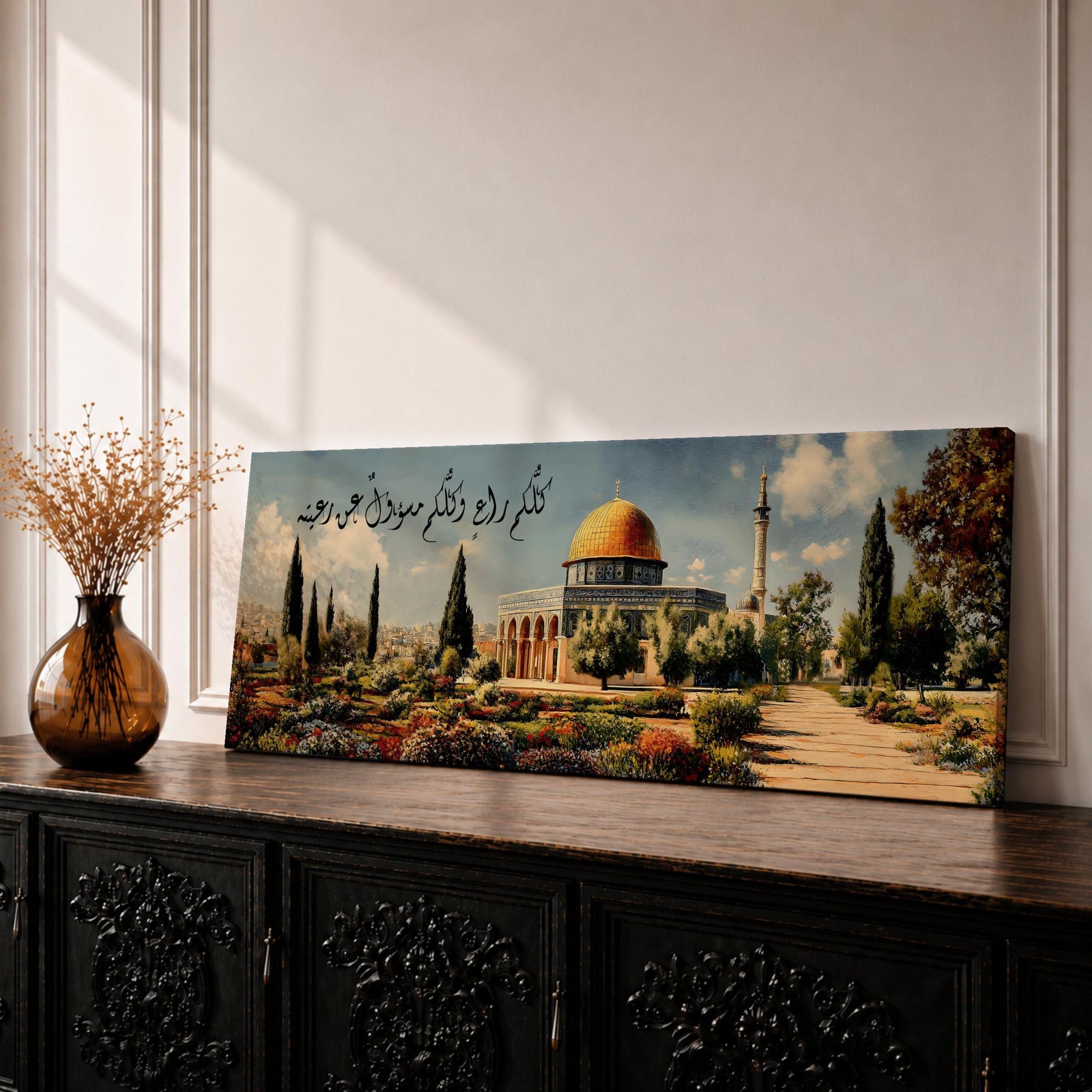 A panoramic painting of the Dome of the Rock with its golden dome rising above a landscaped garden and pathway, surrounded by cypress trees and flowers, with elegant Arabic calligraphy flowing across the sky while the Jerusalem skyline appears softly in the background.