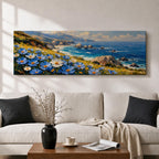 A panoramic coastal landscape painting showing blue and white wildflowers blooming along a grassy cliff overlooking a rocky shoreline and deep blue ocean waves, with distant mountains and scattered sea stacks beneath a bright sky stretching across the wide horizontal composition.