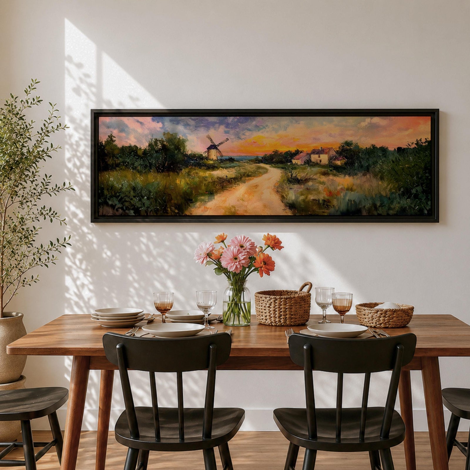 A panoramic countryside landscape painting showing a winding dirt road leading through grassy fields toward a traditional windmill and small farmhouse under a glowing sunset sky, with soft clouds and warm golden light illuminating the rural scenery across the wide composition.