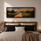 A panoramic countryside landscape painting showing a winding dirt road leading through grassy fields toward a traditional windmill and small farmhouse under a glowing sunset sky, with soft clouds and warm golden light illuminating the rural scenery across the wide composition.