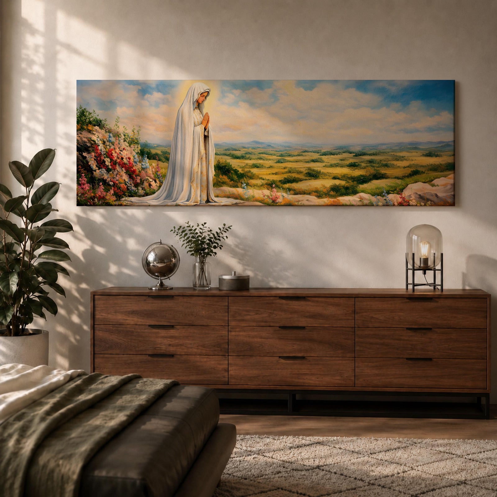 Panoramic painting of the Virgin Mary, the Blessed Mother, standing in prayer on a hillside with colorful flowers overlooking a peaceful countryside landscape beneath a soft blue sky.