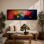A long horizontal panoramic canvas displaying a textured abstract world map with continents formed using thick palette knife strokes. Warm tones of red, orange, and yellow shape the Americas while Europe and Africa appear in lighter hues, and Asia and Australia glow in deep reds against rich blue oceans in a modern atlas style composition.