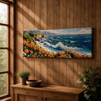 A long panoramic coastal painting showing ocean waves crashing against rocky cliffs while bright orange wildflowers bloom along the shoreline. Deep blue water and white sea foam move toward the coast beneath a clear sky, creating a vibrant seascape landscape in a wide horizontal composition.