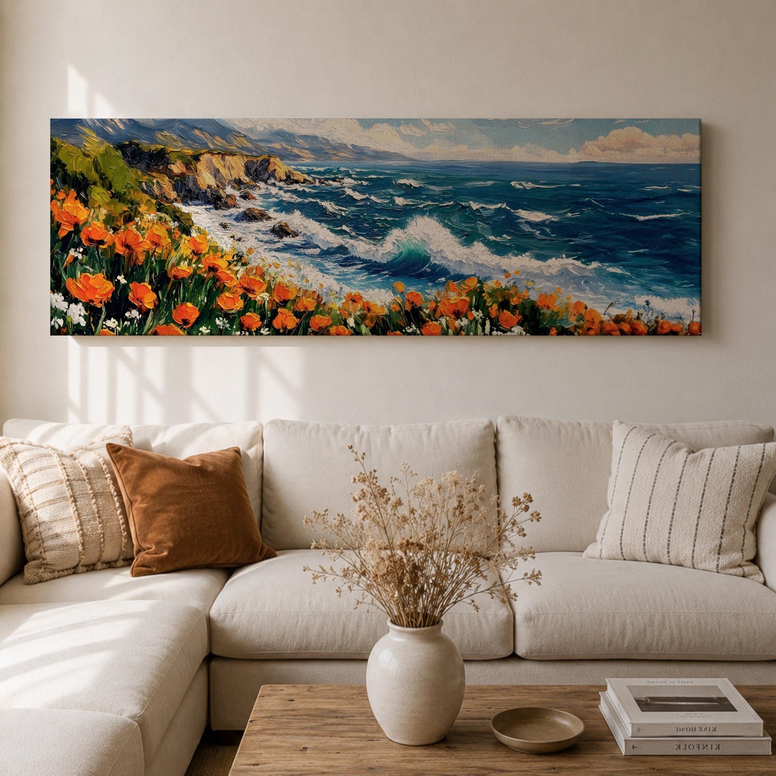 A long panoramic coastal painting showing ocean waves crashing against rocky cliffs while bright orange wildflowers bloom along the shoreline. Deep blue water and white sea foam move toward the coast beneath a clear sky, creating a vibrant seascape landscape in a wide horizontal composition.