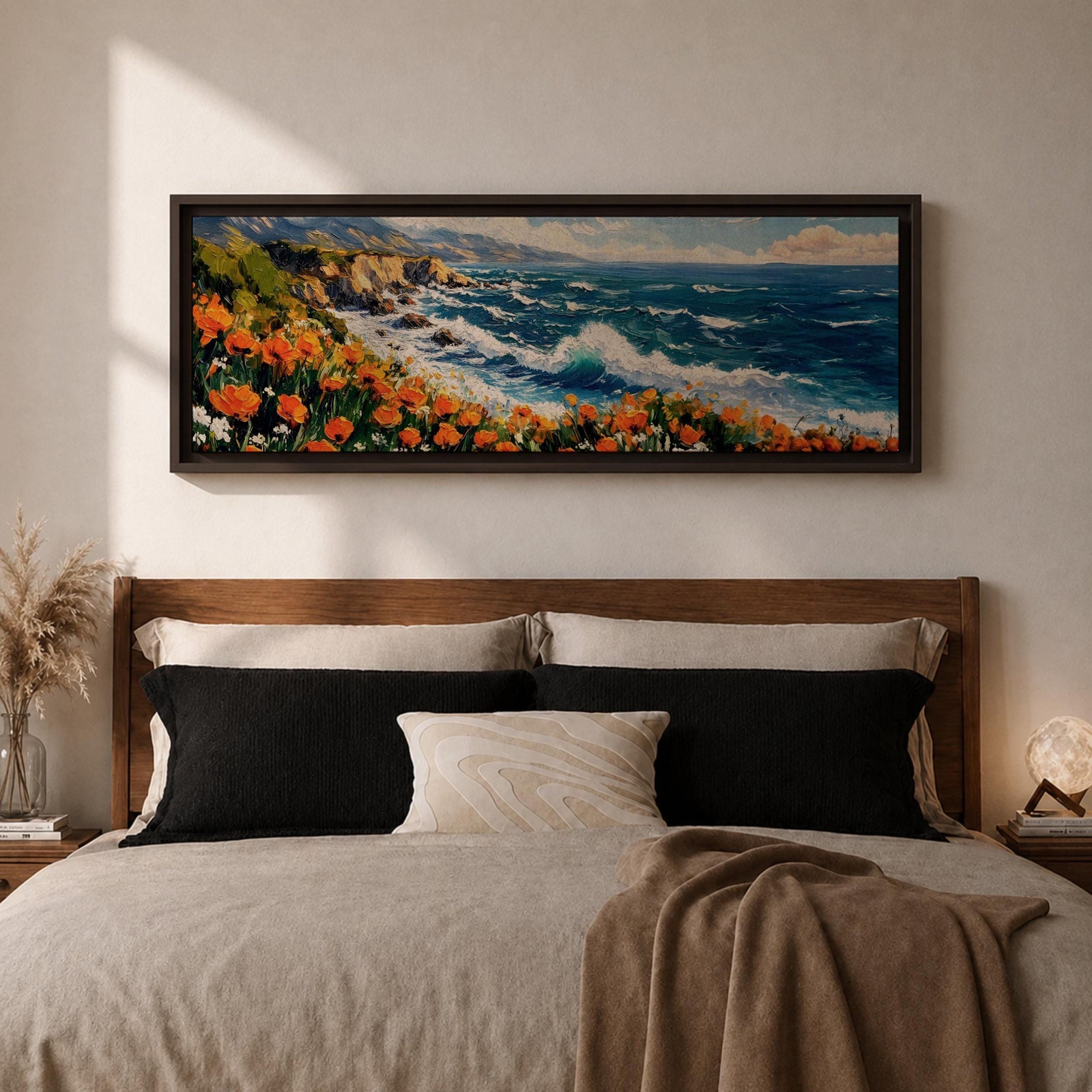 A long panoramic coastal painting showing ocean waves crashing against rocky cliffs while bright orange wildflowers bloom along the shoreline. Deep blue water and white sea foam move toward the coast beneath a clear sky, creating a vibrant seascape landscape in a wide horizontal composition.