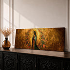 A long panoramic artwork depicting Our Lady of Guadalupe standing in prayer with folded hands and bowed head. She wears a green star covered mantle over a rose colored gown and is surrounded by radiant golden rays and a wreath of vibrant flowers, forming a traditional Catholic Marian image in a wide horizontal composition.
