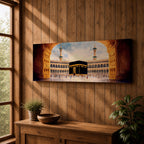 A long panoramic artwork depicting the Kaaba at the center of Masjid Al Haram in Mecca framed by grand mosque arches and tall minarets. The sacred black cube stands in the courtyard while pilgrims gather around it, creating a wide horizontal composition highlighting the holy Islamic sanctuary.