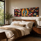 A long panoramic painting of Mary of Guadalupe standing in prayer with hands folded and head bowed, surrounded by radiant golden rays. She wears a blue mantle over a rose colored gown while vibrant roses and colorful flowers fill the background, creating a devotional Catholic Marian image across a wide horizontal composition.