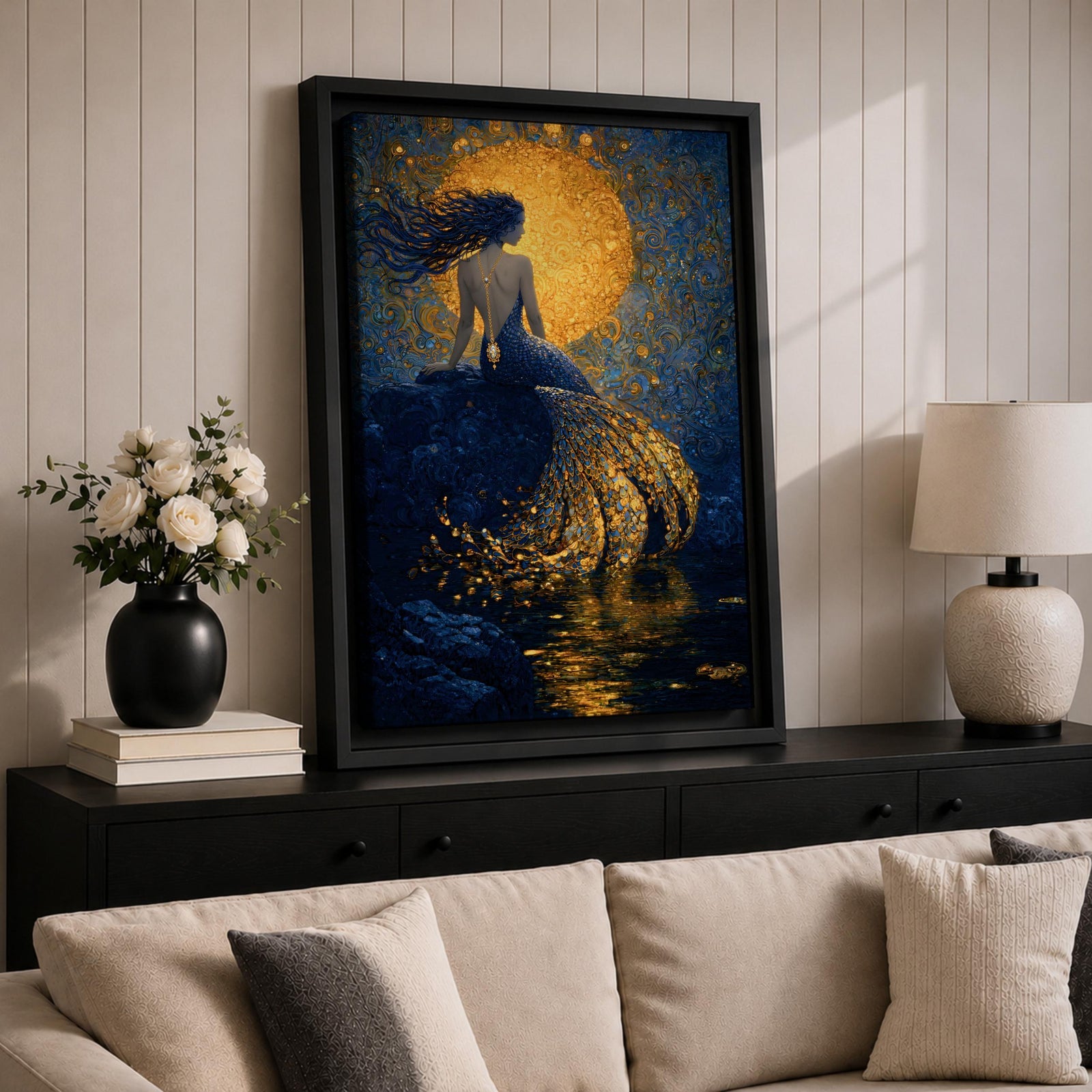 A rich fantasy painting of a mermaid seated on a rocky shore beneath a glowing golden moon, her long flowing hair swept to the side as her detailed tail shimmers with layered gold scales cascading into reflective water, set against deep blue swirling textures that create a dramatic and luminous ocean mythology scene.