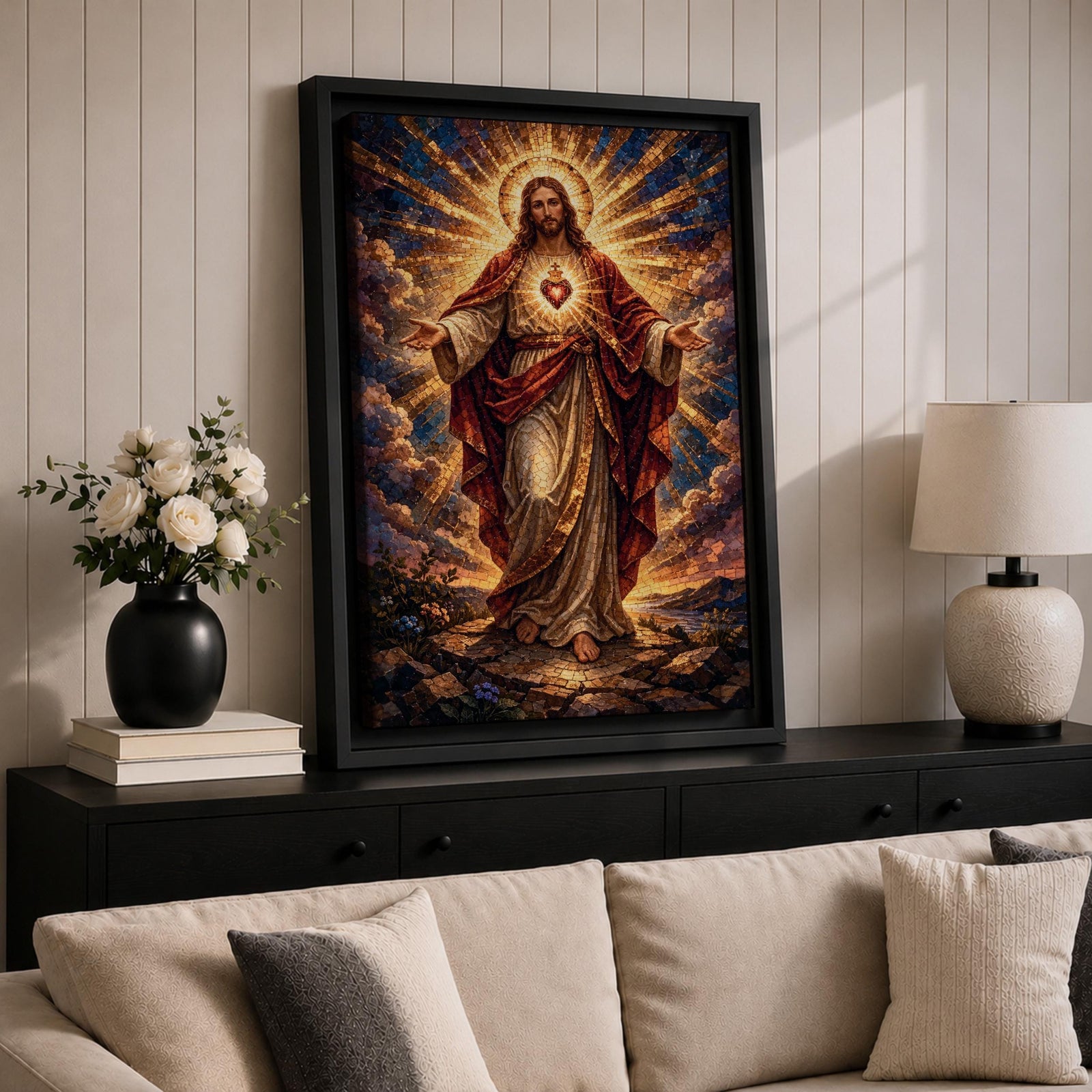 This artwork depicts the Sacred Heart of Jesus rendered in a detailed mosaic style. Jesus is shown with outstretched arms, radiant light emanating from his heart, surrounded by clouds and a glowing halo. The composition uses vibrant mosaic tiles to create a textured, luminous religious image.