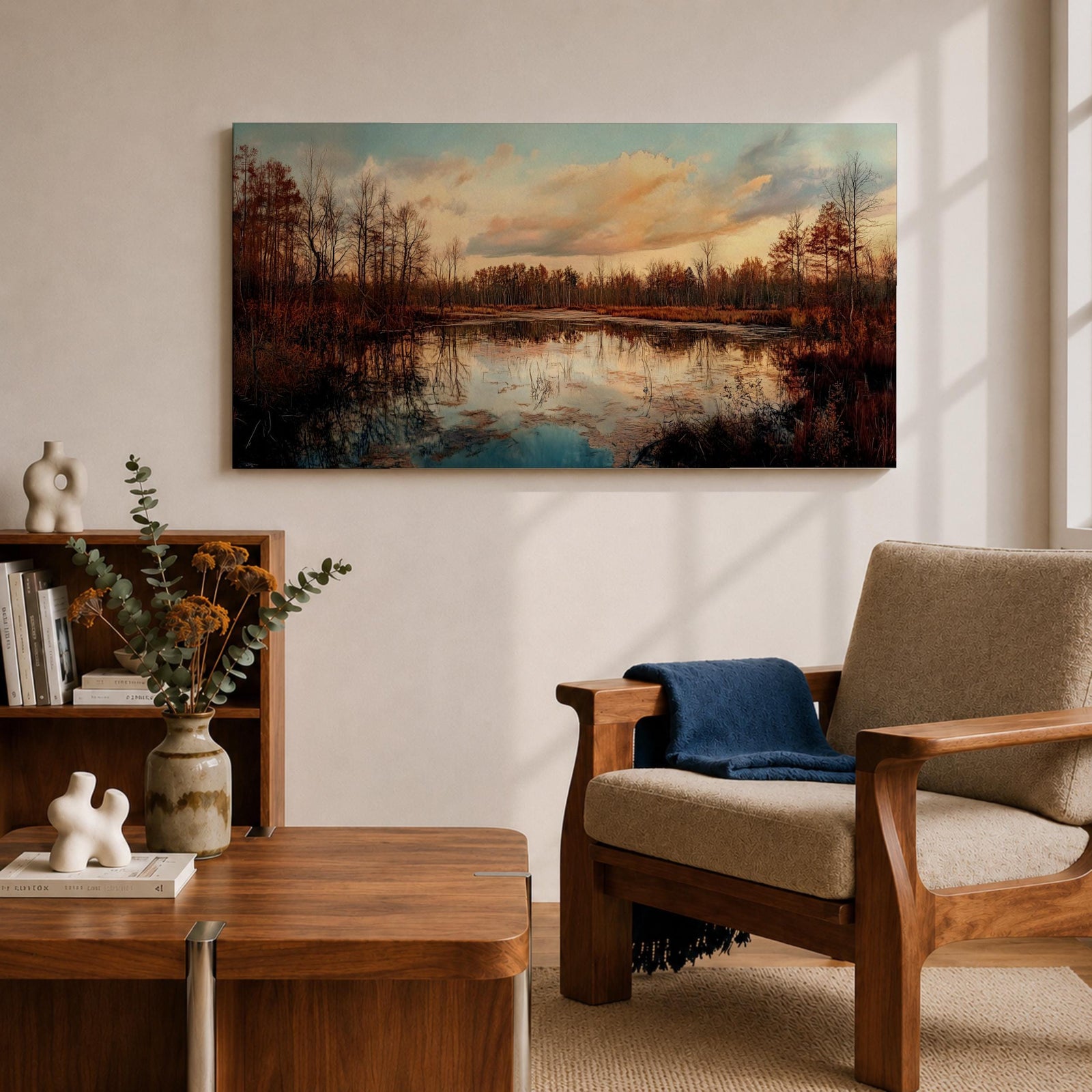 A panoramic painting of a calm lake reflecting autumn trees and a soft sunset sky, with warm earthy tones and bare branches lining the water, rendered in a realistic impressionistic style across a wide landscape composition.
