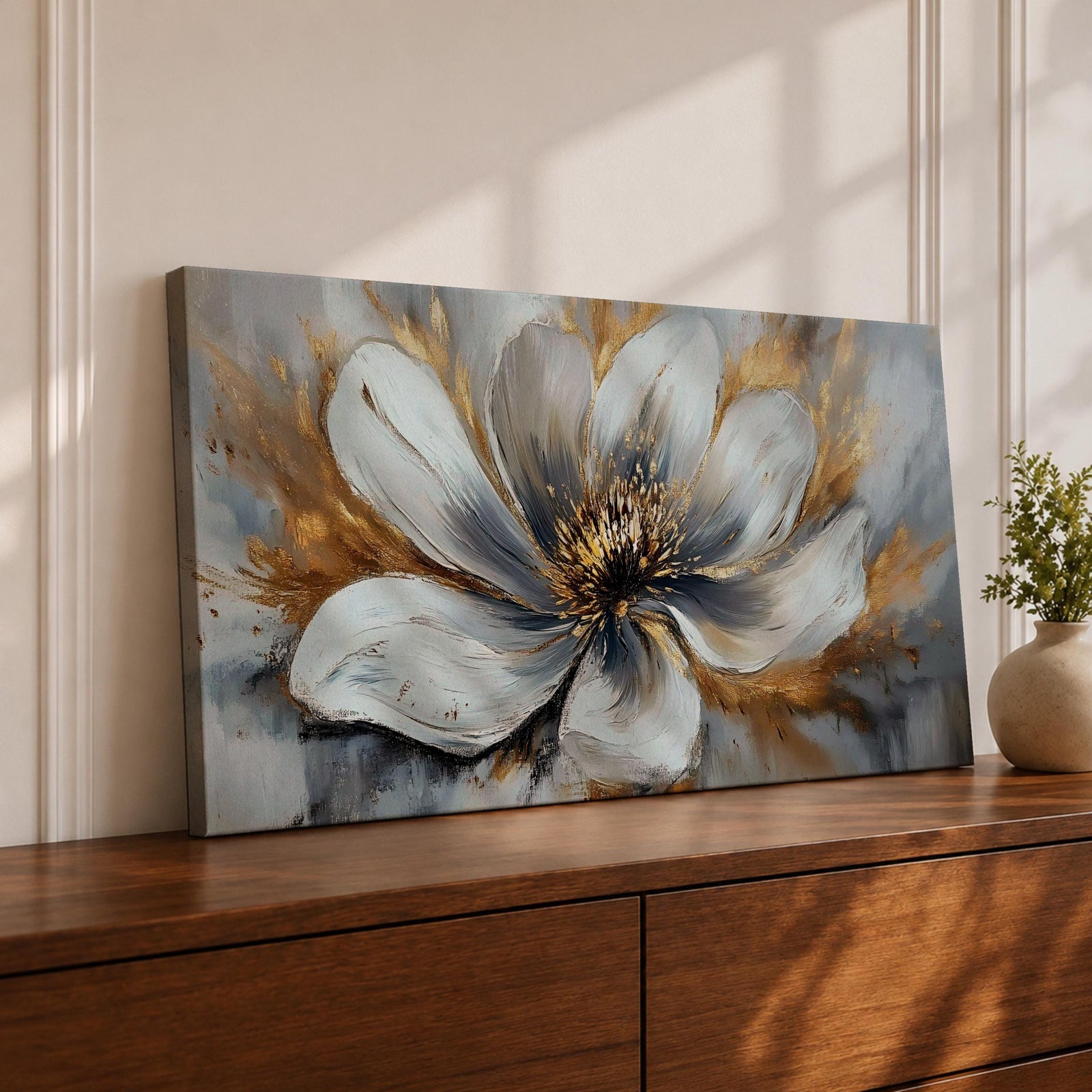 A panoramic abstract painting of a large white flower in full bloom, featuring layered petals with soft gray shading and a detailed textured center, accented by expressive gold brushstrokes that radiate outward, creating depth and contrast across a modern extra wide floral composition.