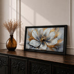 A panoramic abstract painting of a large white flower in full bloom, featuring layered petals with soft gray shading and a detailed textured center, accented by expressive gold brushstrokes that radiate outward, creating depth and contrast across a modern extra wide floral composition.