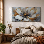 A panoramic abstract painting of a large white flower in full bloom, featuring layered petals with soft gray shading and a detailed textured center, accented by expressive gold brushstrokes that radiate outward, creating depth and contrast across a modern extra wide floral composition.