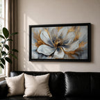 A panoramic abstract painting of a large white flower in full bloom, featuring layered petals with soft gray shading and a detailed textured center, accented by expressive gold brushstrokes that radiate outward, creating depth and contrast across a modern extra wide floral composition.
