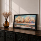 A panoramic impressionist seascape painting of ocean waves rolling onto shore beneath a vast sky filled with large dramatic clouds in soft peach, cream, and blue tones, with textured brushstrokes capturing light reflecting across the water and horizon, creating a serene yet dynamic coastal atmosphere.