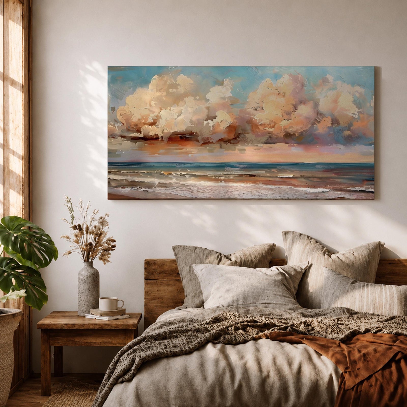A panoramic impressionist seascape painting of ocean waves rolling onto shore beneath a vast sky filled with large dramatic clouds in soft peach, cream, and blue tones, with textured brushstrokes capturing light reflecting across the water and horizon, creating a serene yet dynamic coastal atmosphere.