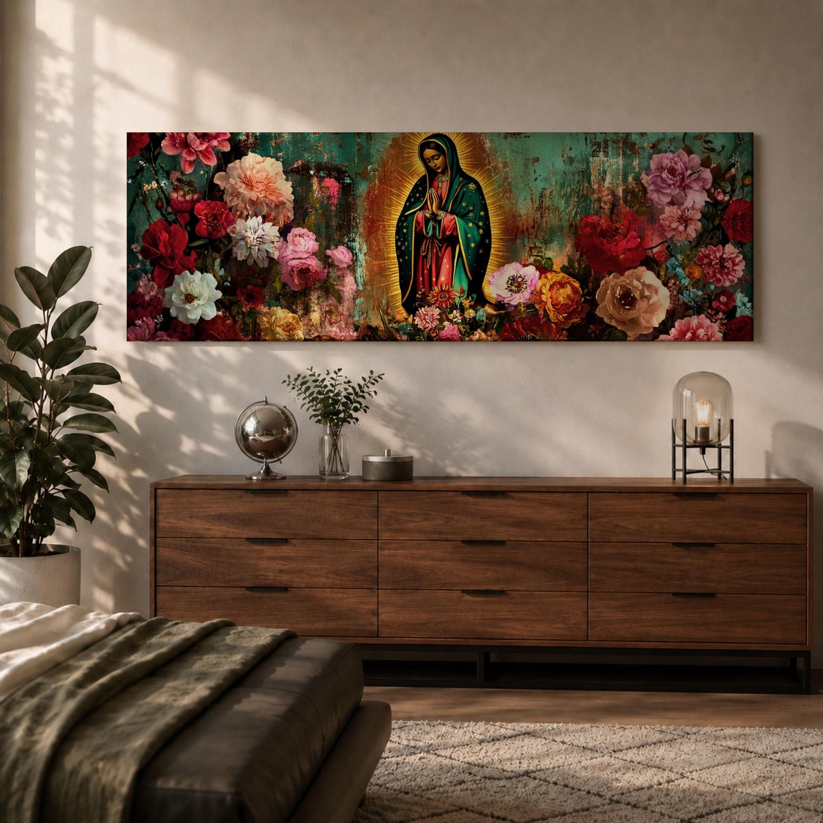 A long narrow panoramic painting shows Virgen de Guadalupe centered in prayer within a radiant halo, surrounded by richly detailed blooming flowers, with textured abstract layers and deep earthy tones blending with vibrant florals to create depth, contrast, and a luminous devotional focal point in an expressive style.