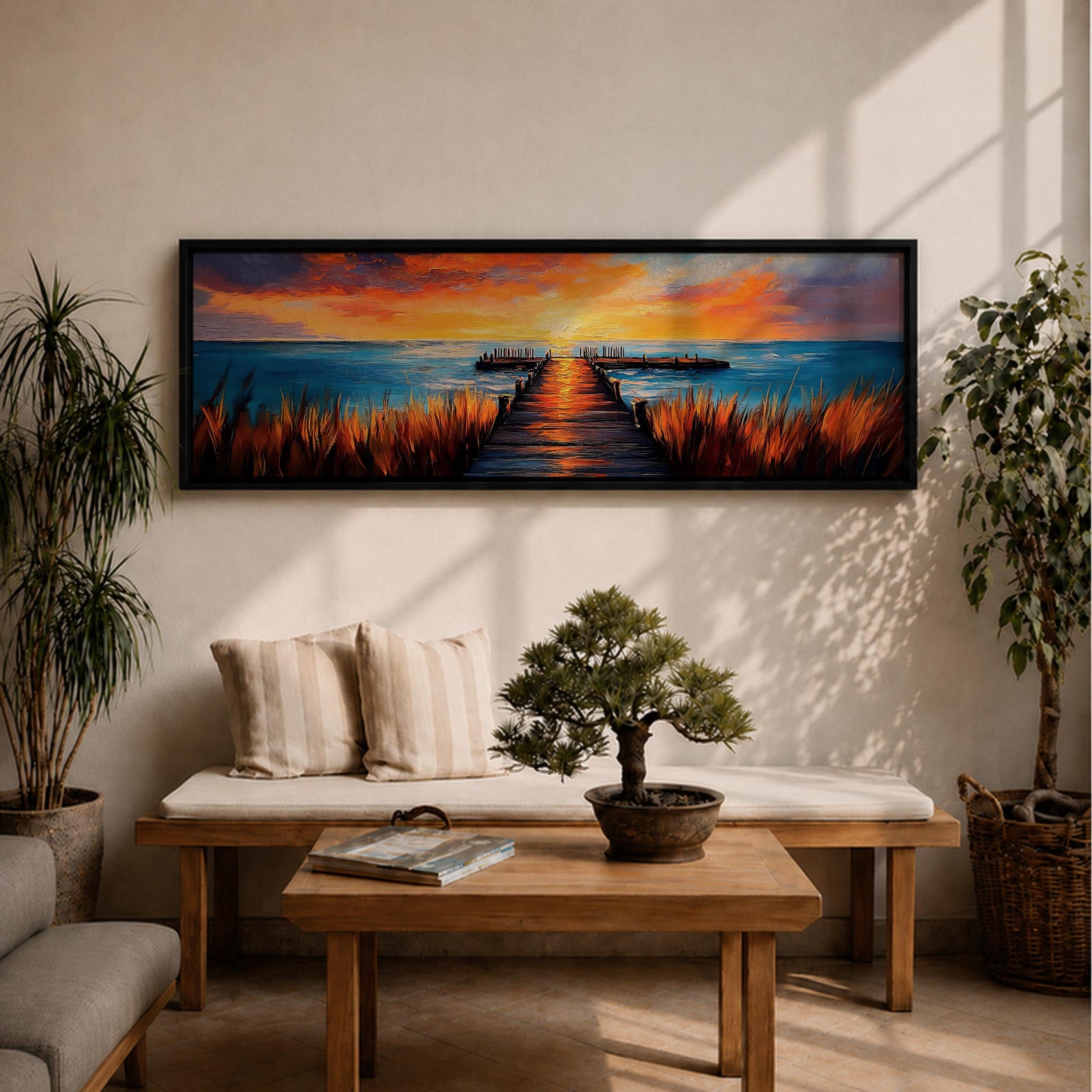 A long narrow panoramic painting depicts a wooden pier extending through tall grasses into calm ocean waters, leading toward a glowing sunset on the horizon, with bold textured brushstrokes and vivid color contrasts capturing reflections of warm light across the water and sky in an expressive contemporary style.