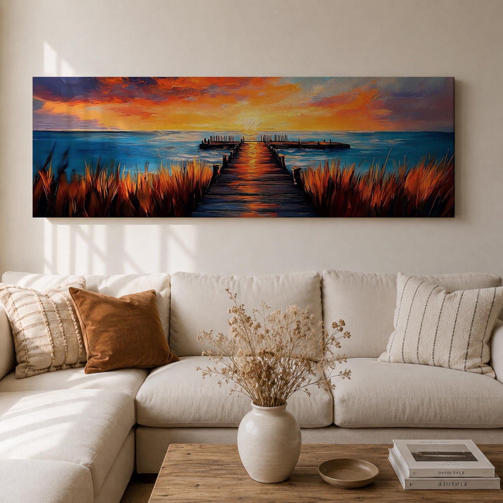 A long narrow panoramic painting depicts a wooden pier extending through tall grasses into calm ocean waters, leading toward a glowing sunset on the horizon, with bold textured brushstrokes and vivid color contrasts capturing reflections of warm light across the water and sky in an expressive contemporary style.