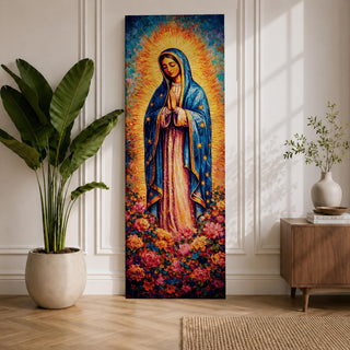 A tall narrow vertical depiction of Our Lady of Guadalupe standing in prayer with hands clasped, wearing a blue star covered mantle and soft pink gown, surrounded by a radiant golden sunburst and dense vibrant floral arrangement at her feet, rendered with rich texture and layered color in a devotional composition.