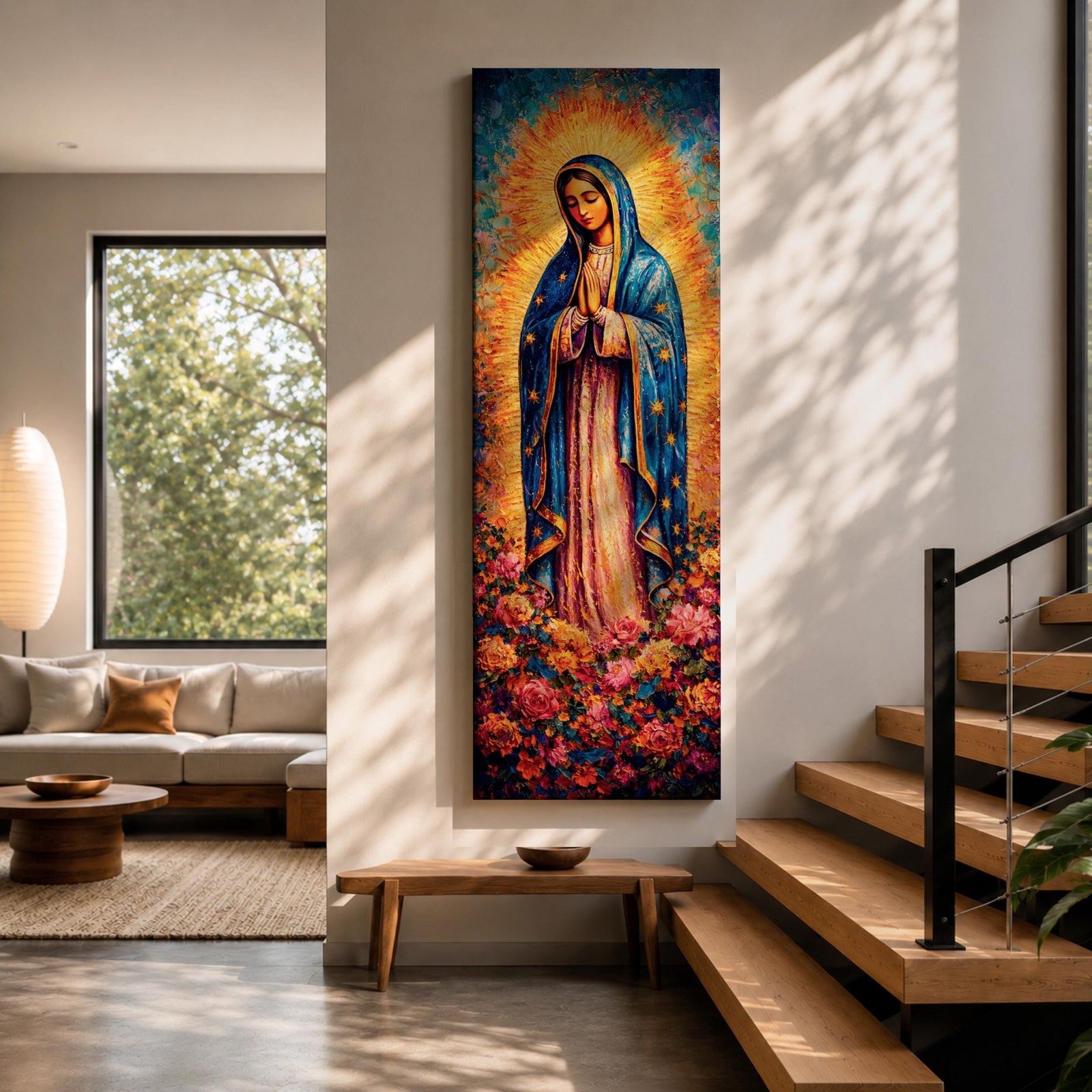 A tall narrow vertical depiction of Our Lady of Guadalupe standing in prayer with hands clasped, wearing a blue star covered mantle and soft pink gown, surrounded by a radiant golden sunburst and dense vibrant floral arrangement at her feet, rendered with rich texture and layered color in a devotional composition.