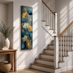 A tall, narrow vertical painting of stylized poppy flowers in layered teal, navy, gold, and soft white tones, featuring textured brushstrokes and metallic accents, with blooms rising along slender stems against a deep blue abstract background, creating a contemporary floral composition with rich contrast and flowing movement.
