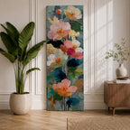 A tall, narrow vertical painting of soft pastel poppy flowers in shades of blush pink, coral, cream, and muted yellow, layered with textured brushstrokes and accented by hints of gold against a cool blue abstract background, with delicate stems and leaves creating a balanced contemporary floral composition.