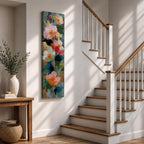 A tall, narrow vertical painting of soft pastel poppy flowers in shades of blush pink, coral, cream, and muted yellow, layered with textured brushstrokes and accented by hints of gold against a cool blue abstract background, with delicate stems and leaves creating a balanced contemporary floral composition.