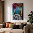 Vibrant Mediterranean patio wall art featuring a sunlit terrace with colorful bougainvillea, a café table and chairs, and a breathtaking blue lake view framed by white columns. Impressionist coastal artwork with rich colors, relaxing vacation ambiance, and European seaside charm.