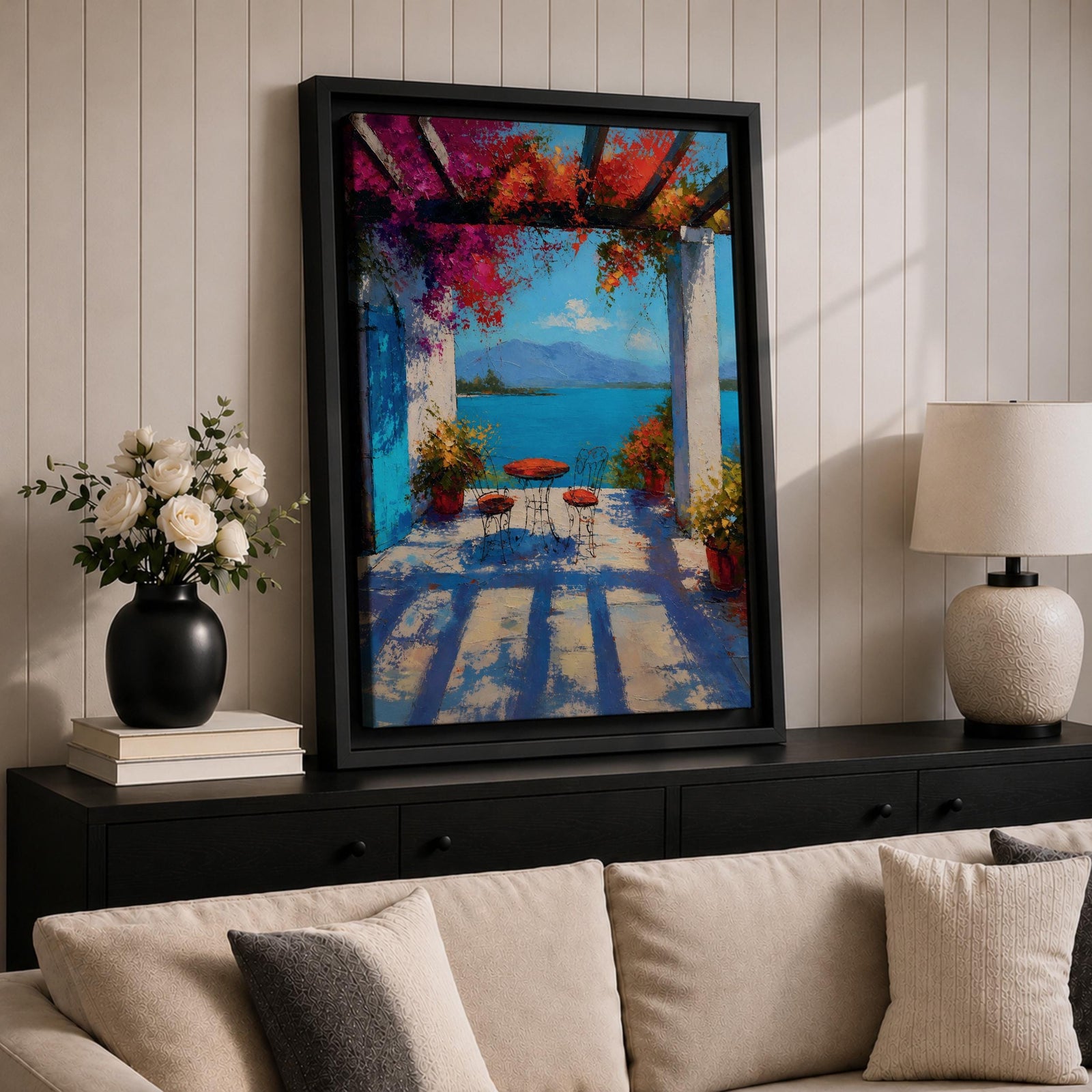 Vibrant Mediterranean patio wall art featuring a sunlit terrace with colorful bougainvillea, a café table and chairs, and a breathtaking blue lake view framed by white columns. Impressionist coastal artwork with rich colors, relaxing vacation ambiance, and European seaside charm.
