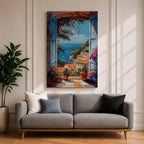 Colorful Mediterranean coastal village seen through open blue shutters overlooking a sparkling sea. Terracotta rooftops, blooming flowers, palm trees, and boats create a vibrant Italian seaside landscape in an impressionist-style framed canvas wall art.