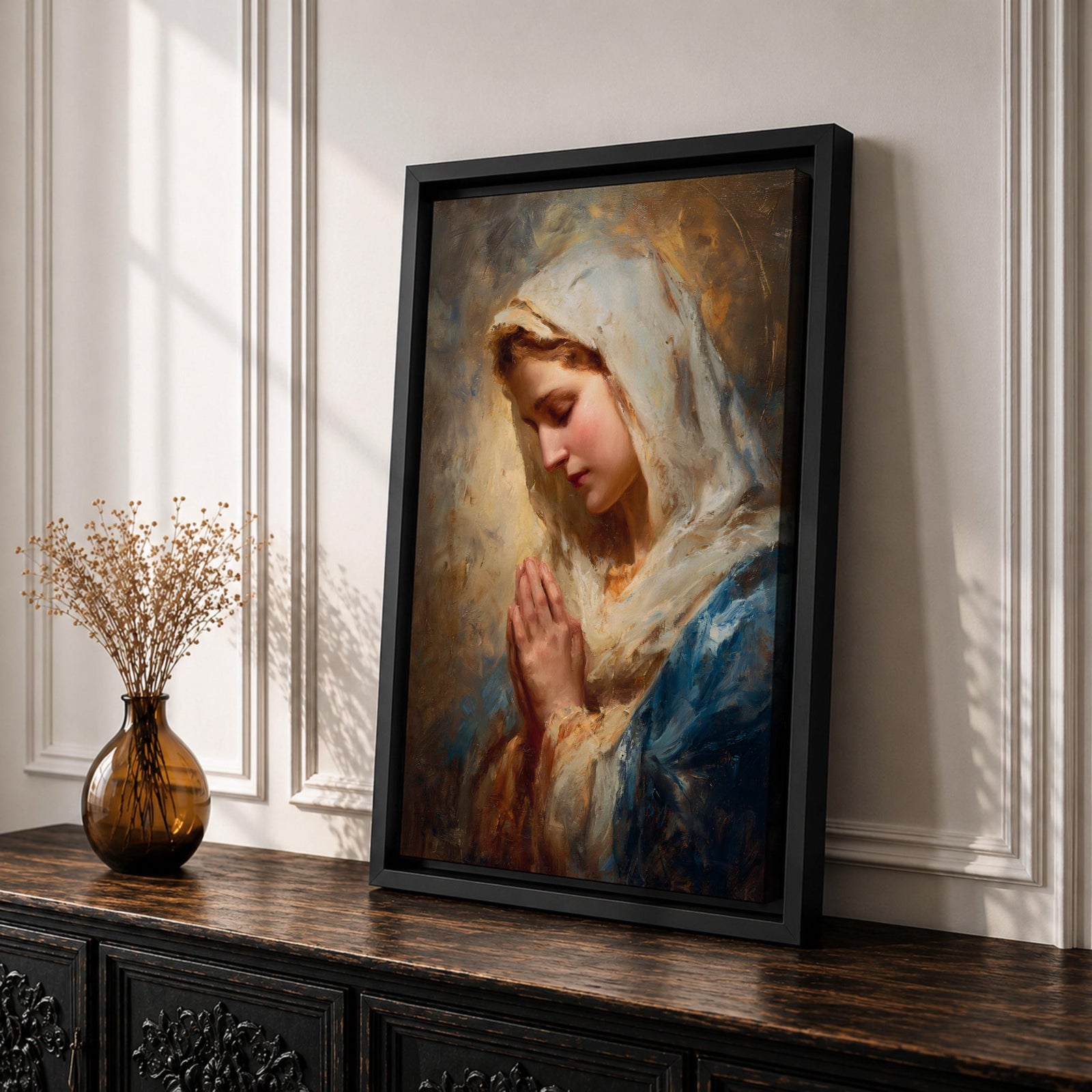 Sacred Catholic wall art featuring the Virgin Mary in prayer with hands clasped and eyes gently lowered. Soft golden light illuminates her serene expression, while rich blue garments and impressionist brushwork create a timeless devotional portrait ideal for prayer rooms and Christian homes.