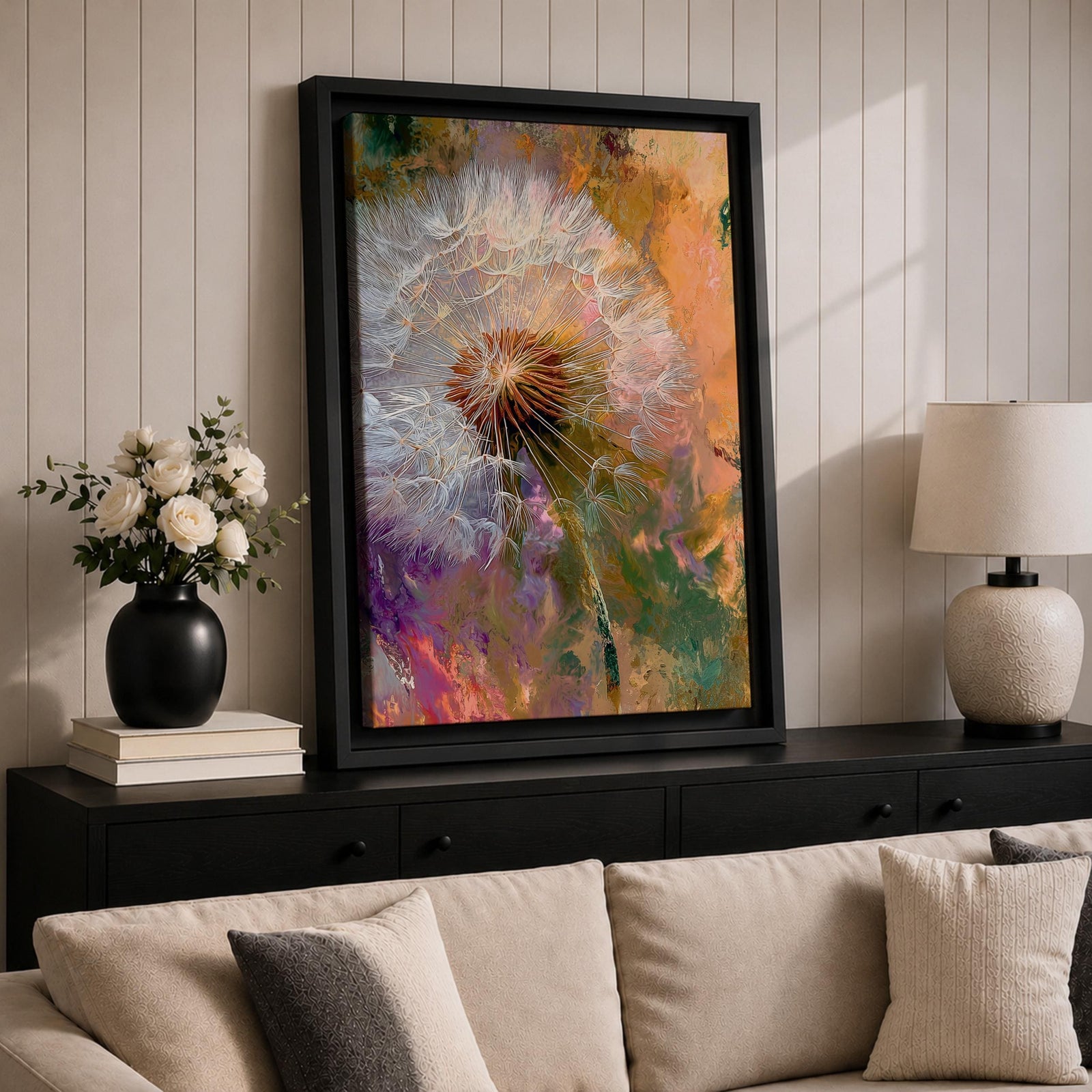 Close-up of a dandelion seed head with fine white filaments against a colorful abstract background featuring warm tones of orange, purple, and green, rendered in an abstract botanical style on a framed canvas.