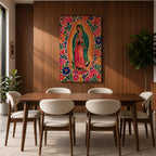 Our Lady of Guadalupe wall art featuring the Virgin Mary in prayer surrounded by vibrant floral folk art patterns and a radiant golden aura. Bright pink, blue, orange, and red blossoms frame this colorful Mexican Catholic artwork, creating a joyful devotional centerpiece for home décor.
