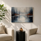A framed canvas painting depicting a serene winter lake landscape with bare trees reflected in still water. The scene features a quiet woodland setting with leafless trees and subtle earthy tones, capturing the calm and reflective nature of a winter forest by the lake.