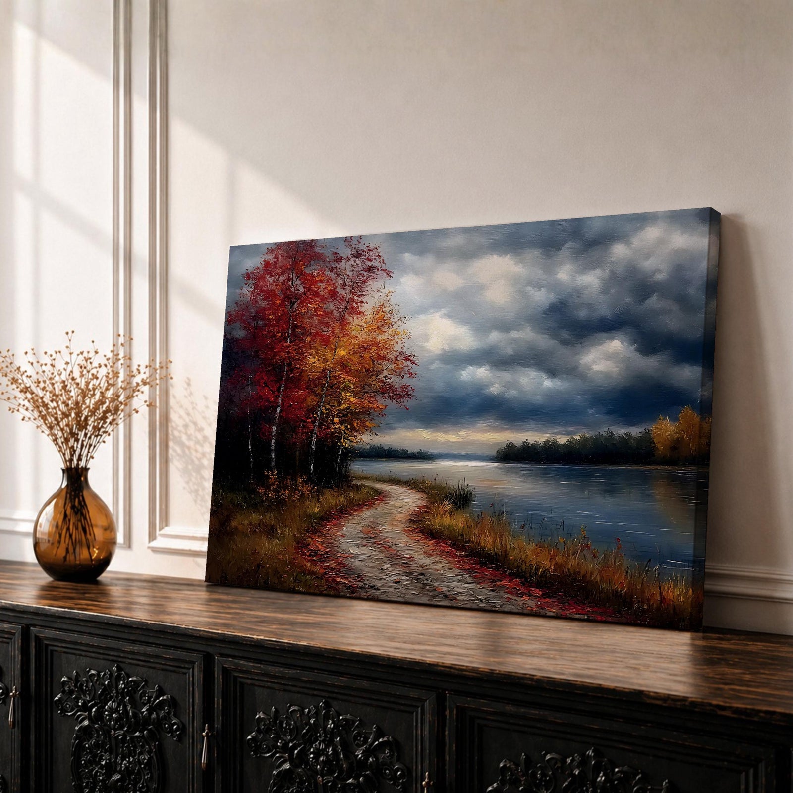A framed canvas painting depicting an autumn landscape with a winding path along a riverbank, bordered by trees with vibrant fall foliage. The scene captures a moody sky with clouds, rendered in a vintage style emphasizing texture and rich colors.